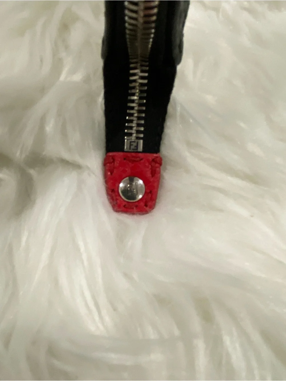 Fendi Selleria flat clutch bag with red stitching and red leather handle